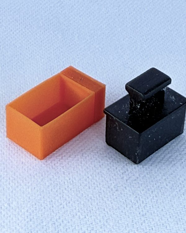 DuCSec SFP next to the dust plug of an SFP cage